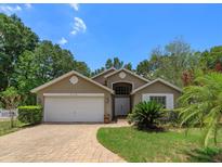 One-story house with a two-car garage and well-maintained landscaping at 2104 Cranberry Isles Way, Apopka, FL 32712