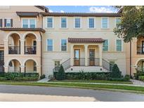 Elegant two-story townhouse featuring a tile roof and a beautifully landscaped entrance at 417 Pavia Loop, Lake Mary, FL 32746