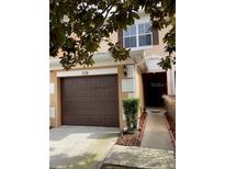 Two-story townhome with attached garage and landscaped walkway at 538 Bexley Dr, Davenport, FL 33897