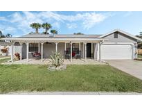 Charming one-story home with a covered porch and a two-car garage at 798 Saint Johns River Dr, Sanford, FL 32773