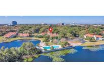 Beautiful aerial view of community pool, lake, and lush landscaping at this lovely condo community at 1000 Winderley Pl # 143, Maitland, FL 32751