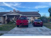 Tan one-story house with a driveway and landscaping at 4415 Continental Blvd, Orlando, FL 32808