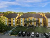 Aerial view of apartment buildings with parking and landscaping at 5271 Images Cir # 108, Kissimmee, FL 34746