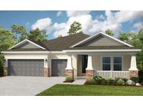 Two-story house with gray and beige siding, two-car garage, and landscaping at 5296 Bowspirit Way, St Cloud, FL 34769