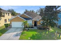 Attractive single-story house with a two-car garage and landscaped yard at 590 Michigan Estates Cir, St Cloud, FL 34769