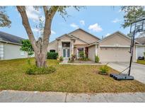 Beautiful house with a well-maintained lawn and a two-car garage at 9831 Kona Isle Ct, Orlando, FL 32817