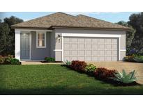 One-story house with gray siding, two-car garage, and landscaping at 248 Links Terrace Blvd, Daytona Beach, FL 32124
