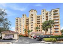 Elegant multi-story building with palm trees and gated entrance at 263 Minorca Beach Way # 301, New Smyrna Beach, FL 32169