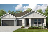 Two-story house with gray siding, dark gray garage doors, and landscaping at 5278 Bowspirit Way, St Cloud, FL 34769