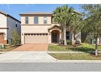 Two-story house with a two-car garage and manicured lawn at 8833 Corcovado Dr, Kissimmee, FL 34747