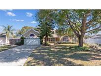 Attractive single-story house with a landscaped yard and driveway at 1921 Nicholas Pl, St Cloud, FL 34771
