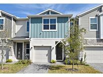 Two-story townhome with neutral siding and a paved driveway at 1389 Captiva Cv # 20, Sanford, FL 32771