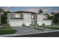 Two-story townhome with gray siding, three-car garage, and landscaping at 2575 Winsome Way, Davenport, FL 33896