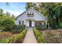 Charming light blue house with white picket fence and landscaped yard at 810 E Central Blvd, Orlando, FL 32801