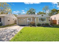 Charming single-story home featuring a well-maintained lawn and attached garage at 912 Stetson St, Orlando, FL 32804