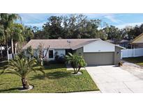 Attractive single-story house with a landscaped lawn and two-car garage at 127 Kaywood Dr, Sanford, FL 32771