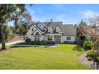 Two-story house with white exterior, gray roof, and landscaped lawn at 1470 Place Picardy, Winter Park, FL 32789