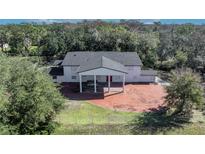 Aerial view of a large house with a pond and surrounding landscape at 2323 Tuskawilla Rd, Oviedo, FL 32765