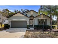 Curb appeal abounds at this charming one-story home featuring a two-car garage at 24414 Woodhill Ct, Sorrento, FL 32776