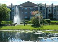 Apartment building with lake view and fountain at 5545 Devonbriar Way # 205, Orlando, FL 32822