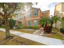 Two-story house with orange siding, landscaping, and a walkway at 6370 Golden Dewdrop Trl, Windermere, FL 34786