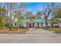 Charming single story home with a green metal roof and spacious yard at 750 S Dudley Ave, Bartow, FL 33830