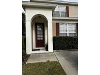 Inviting home exterior featuring a charming entryway and well-manicured landscaping at 2407 Silver Palm Dr, Kissimmee, FL 34747