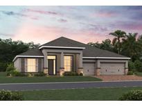 Two-story home with a gray exterior, three-car garage, and landscaping at 2710 Ravencliffe Ter, Oviedo, FL 32765