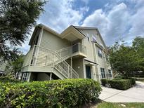 Inviting two-story condo featuring private entry, lush landscaping, and tranquil surroundings at 3721 S Lake Orlando Pkwy # 2, Orlando, FL 32808