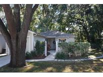 Front view of charming house with walkway and mature trees at 505 Harvard Pl, Apopka, FL 32703