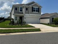 Charming two-story home featuring a two-car garage, well-manicured lawn and pleasant curb appeal at 768 Staffora St, Haines City, FL 33844