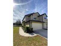 Two-story house with attached garage and landscaped front yard at 1100 Pavia Dr, Apopka, FL 32703