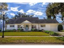 Charming single-story home with a well-manicured lawn and attached garage at 1102 Wilkinson St, Orlando, FL 32803