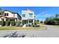 Modern two-story home with unique architectural details and drought-tolerant landscaping at 14519 Crested Plume Dr, Winter Garden, FL 34787