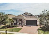 One-story home with green garage door and landscaped yard at 1809 Hawksbill Ln, St Cloud, FL 34771