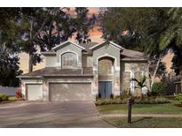 Charming two-story home featuring a three-car garage, well-maintained landscaping, and classic architectural details at 3138 Jamber Dr, Ocoee, FL 34761