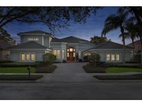 Elegant exterior with a well-maintained lawn and a circular driveway leading to the front entrance at 661 Cricklewood Ter, Lake Mary, FL 32746