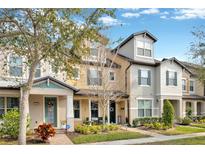 Attractive townhouses with landscaped yards and inviting front porches at 7387 Duxbury Ln, Winter Garden, FL 34787