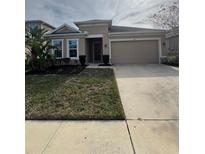 One-story home with attached garage and well-manicured lawn at 984 Maypole Dr, Apopka, FL 32703