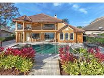 Luxury home with inviting pool, spa, and expansive patio perfect for outdoor entertaining at 10018 Lone Tree Ln, Orlando, FL 32836
