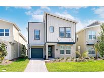 Two-story modern home with gray siding and a gray garage door at 4152 Paragraph Dr, Kissimmee, FL 34746