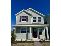 Two-story house with green siding, burgundy door, and landscaping at 520 Orient Ave, Debary, FL 32713