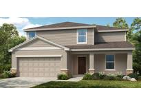 Two-story house with neutral siding, two-car garage, and landscaping at 5829 Gingham Dr, Kissimmee, FL 34758