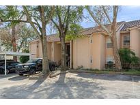 Condo building exterior with parking and landscaping at 670 Sandy Neck Ln # 103, Altamonte Springs, FL 32714