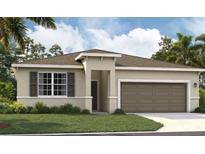 One-story home with two-car garage, neutral color palette, and landscaping at 9552 Starling Loop, Leesburg, FL 34788