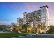 Stunning exterior view of the multi-story residence with private balconies, lush landscaping and serene water feature at 10601 Autumn Mist Ln # 302, Golden Oak, FL 32836