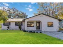 Newly renovated house with a stone facade and a well-manicured lawn at 137 Scott Dr, Sanford, FL 32771