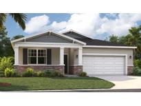 Charming single-Gathering home with stone accents, covered entry, two-car garage, and a well-manicured lawn at 1688 Blue Lagoon Cir, Mascotte, FL 34753