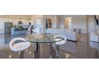 Bright, open-concept living space with modern furnishings and a sleek dining area at 4731 Clock Tower Dr # 401, Kissimmee, FL 34746