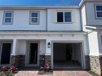 Charming townhome with brick paver walkway, one-car garage and stone accents at 5110 Rain Shadow Dr, St Cloud, FL 34772